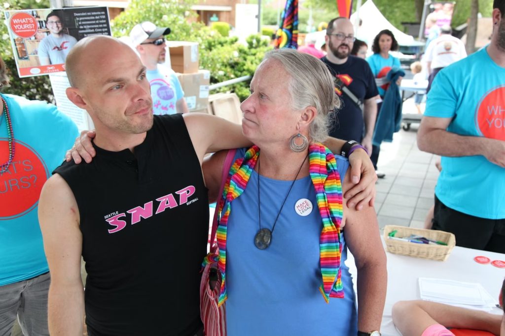 Carol Glenn (r) at PrideFest. (Photo by Alex Stonehill for KUOW)